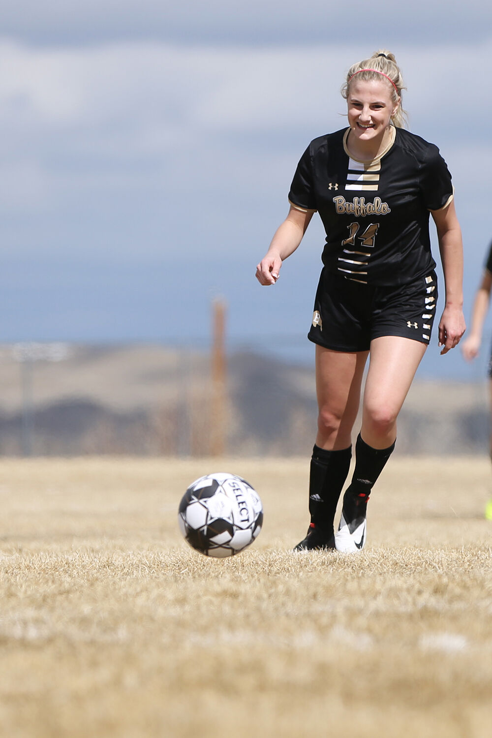 Kendra Schultze laughs after passing the ball